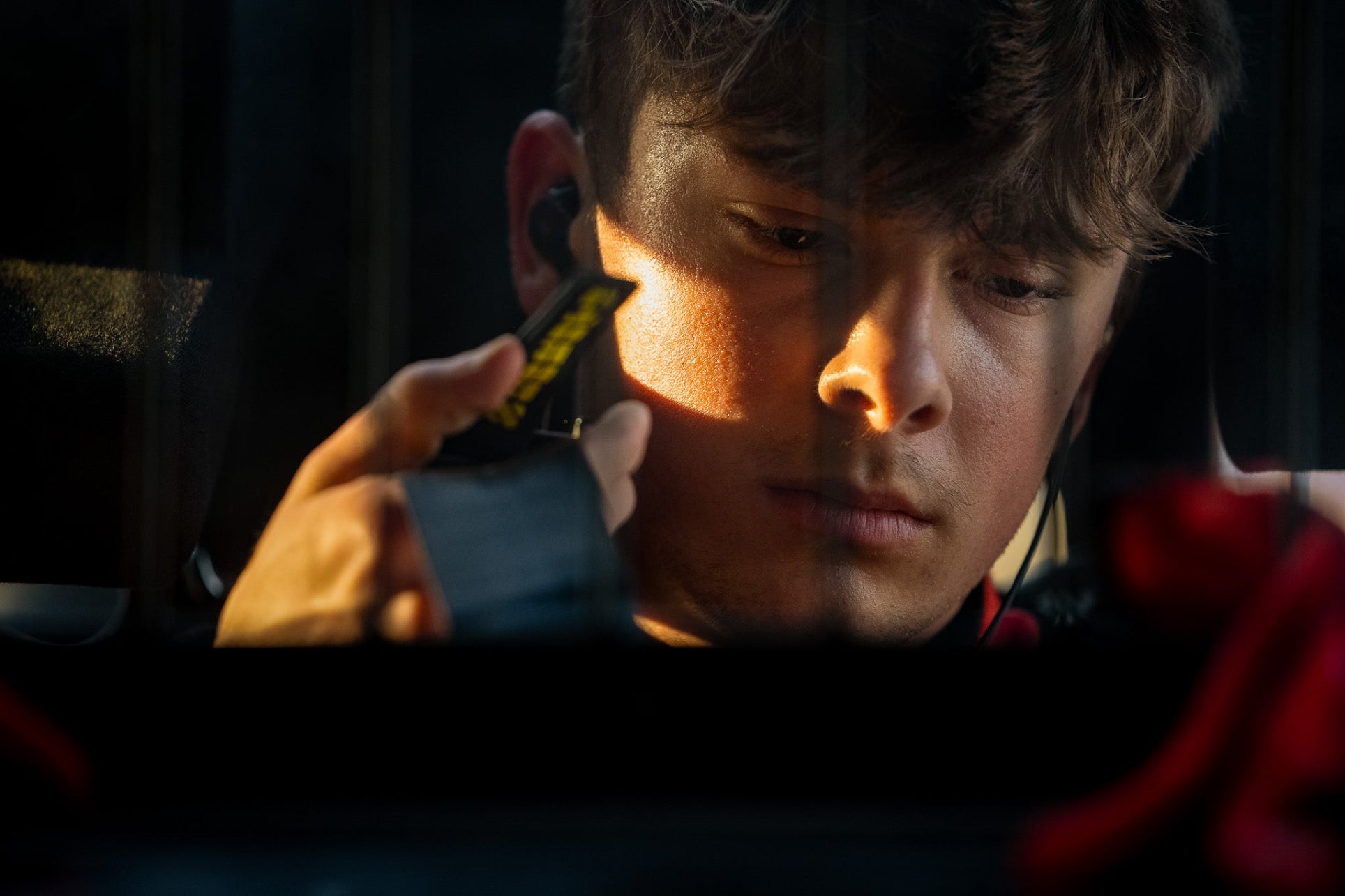 Person using a smartphone with a dark background
